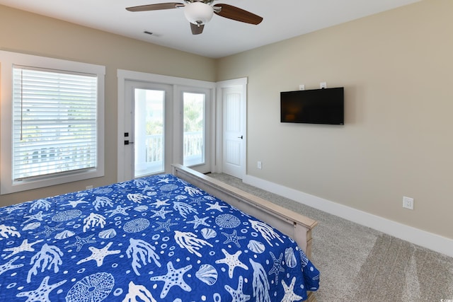 carpeted bedroom featuring visible vents, baseboards, access to exterior, and a ceiling fan