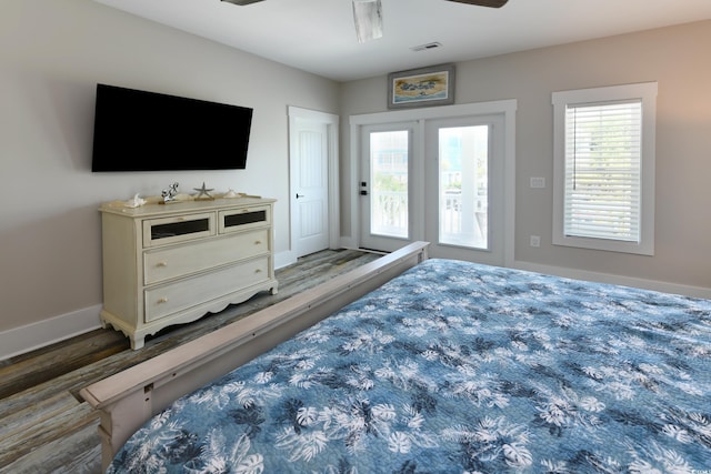 bedroom with visible vents, baseboards, wood finished floors, a ceiling fan, and access to outside