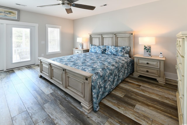 bedroom featuring dark wood finished floors, a ceiling fan, and visible vents