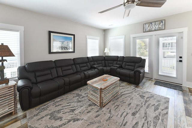 living area with wood-type flooring and ceiling fan