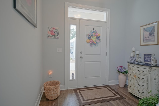 entryway featuring wood finished floors and baseboards