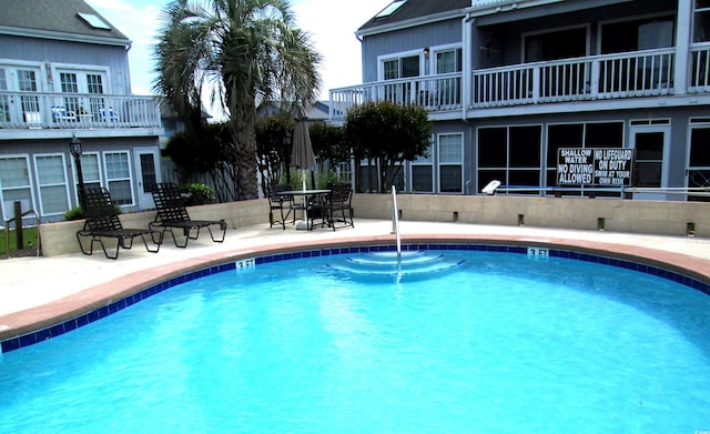 community pool with a patio area