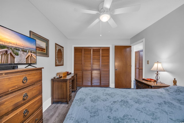 bedroom with ceiling fan, a closet, and wood finished floors