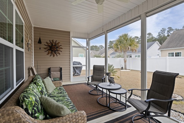 sunroom / solarium featuring ceiling fan