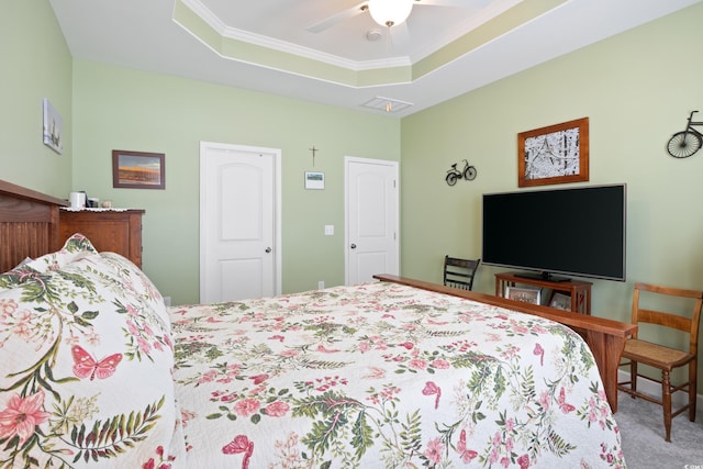 bedroom featuring visible vents, ceiling fan, carpet, ornamental molding, and a raised ceiling