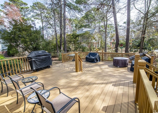 wooden deck with a grill