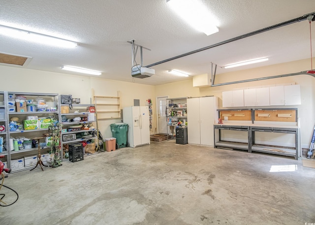 garage with white fridge with ice dispenser and a garage door opener