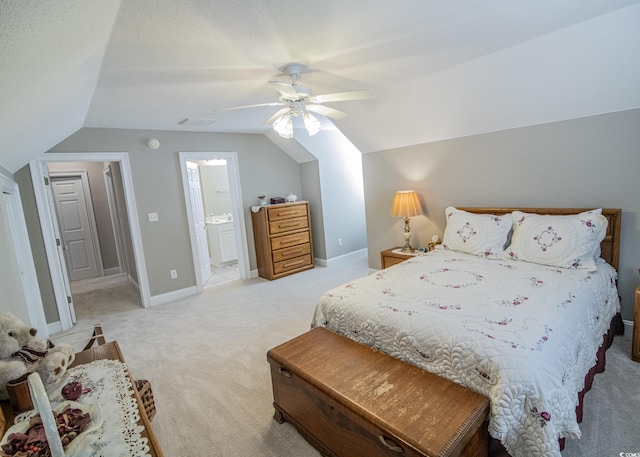 bedroom with light colored carpet, connected bathroom, vaulted ceiling, ceiling fan, and baseboards