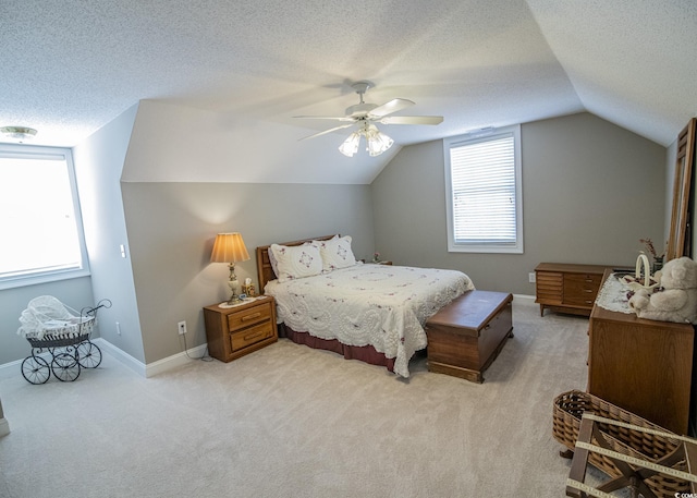 bedroom with lofted ceiling, light colored carpet, a textured ceiling, and baseboards