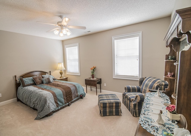 bedroom featuring ceiling fan, carpet flooring, visible vents, and baseboards