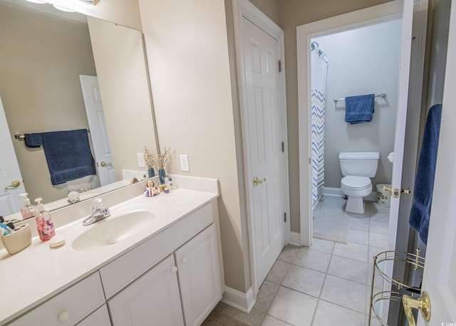 full bathroom with toilet, tile patterned flooring, vanity, and baseboards