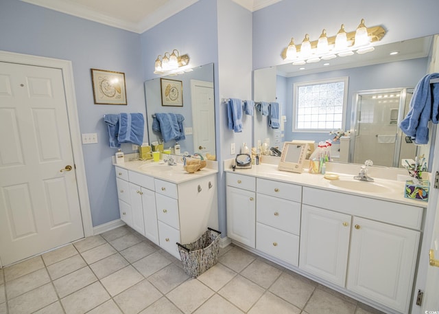 bathroom with tile patterned flooring, two vanities, a sink, ornamental molding, and a stall shower