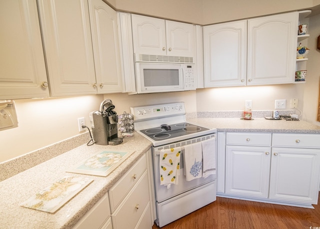 kitchen featuring light countertops, white appliances, white cabinets, and light wood-style floors