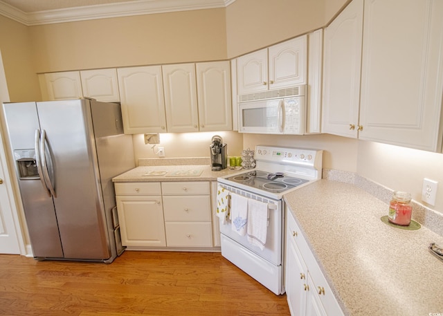 kitchen with white appliances, white cabinets, light wood-style flooring, light countertops, and crown molding