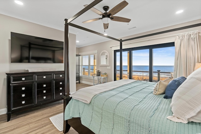 bedroom with baseboards, ornamental molding, wood finished floors, a water view, and recessed lighting