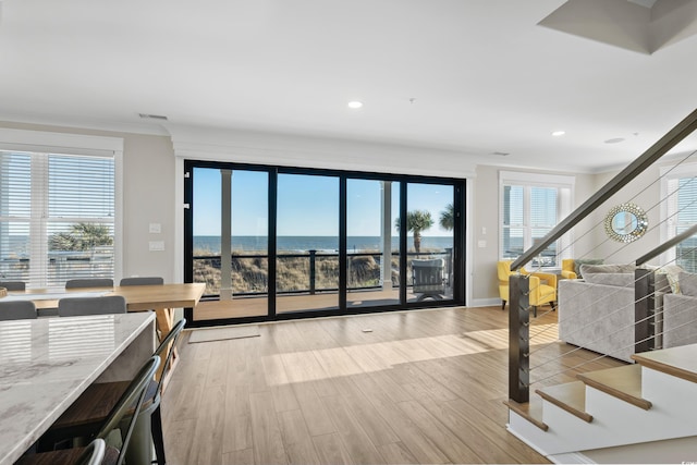 unfurnished living room with recessed lighting, visible vents, light wood finished floors, and stairs