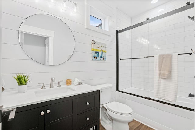 full bathroom featuring enclosed tub / shower combo, vanity, toilet, and wood finished floors