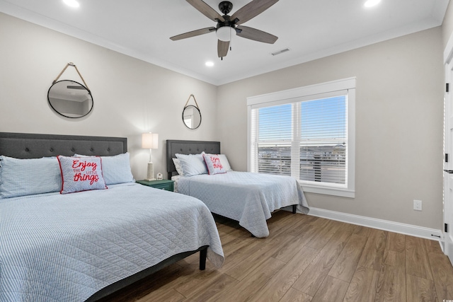 bedroom featuring recessed lighting, visible vents, ornamental molding, wood finished floors, and baseboards