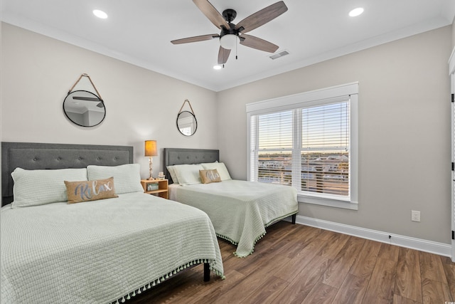 bedroom with recessed lighting, visible vents, ornamental molding, wood finished floors, and baseboards