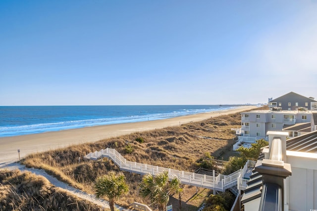 water view featuring a view of the beach and fence