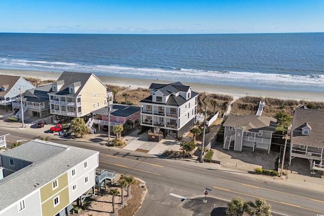 birds eye view of property with a beach view and a water view