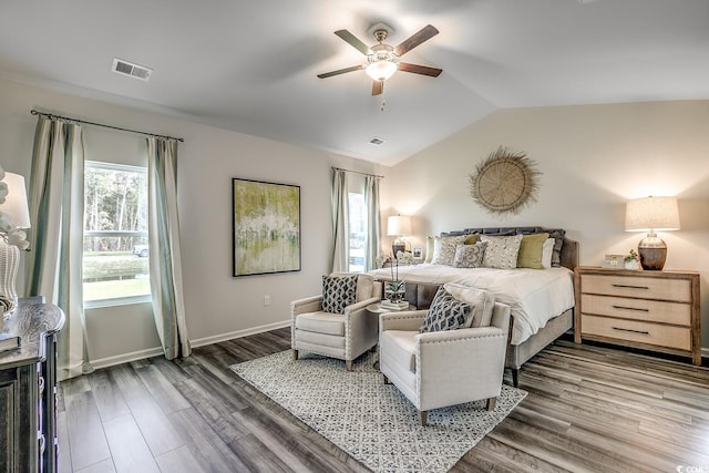 bedroom with visible vents, baseboards, wood finished floors, and vaulted ceiling