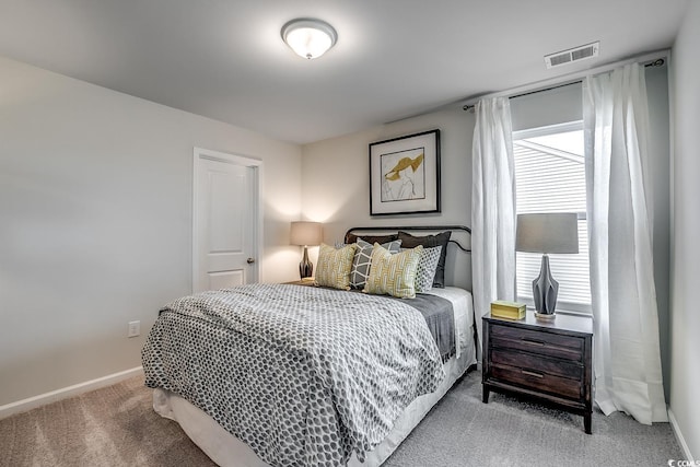 bedroom featuring visible vents, baseboards, and carpet