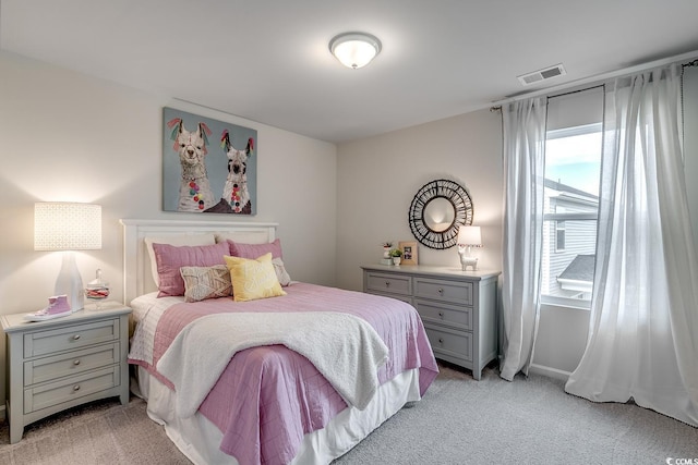 bedroom featuring visible vents, light colored carpet, and baseboards