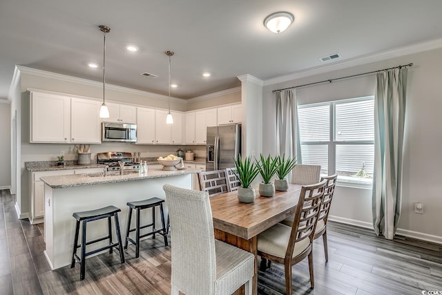 dining area with baseboards, dark wood-style floors, visible vents, and ornamental molding