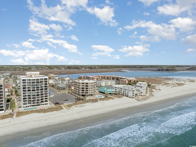 birds eye view of property featuring a water view and a view of the beach