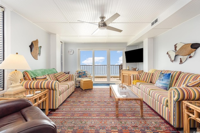 living room with visible vents and a ceiling fan