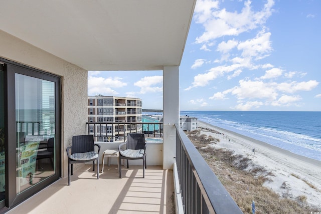 balcony with a beach view and a water view