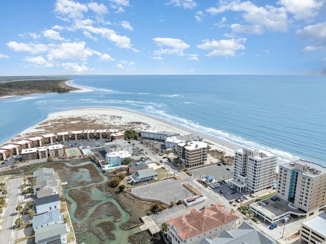 drone / aerial view with a water view and a beach view