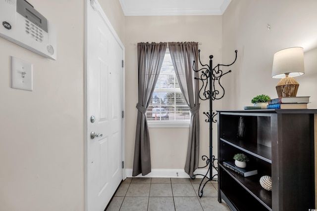 doorway to outside with light tile patterned floors, baseboards, and crown molding