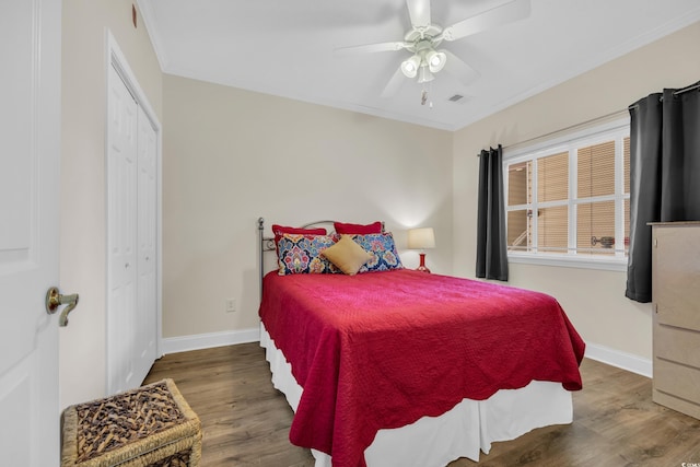 bedroom featuring crown molding, wood finished floors, and baseboards