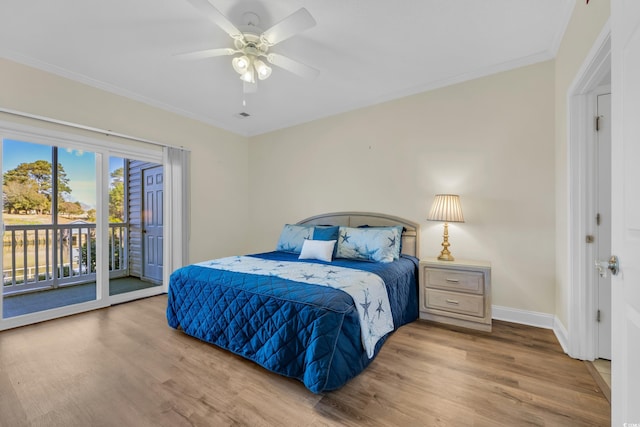 bedroom featuring a ceiling fan, wood finished floors, baseboards, ornamental molding, and access to outside