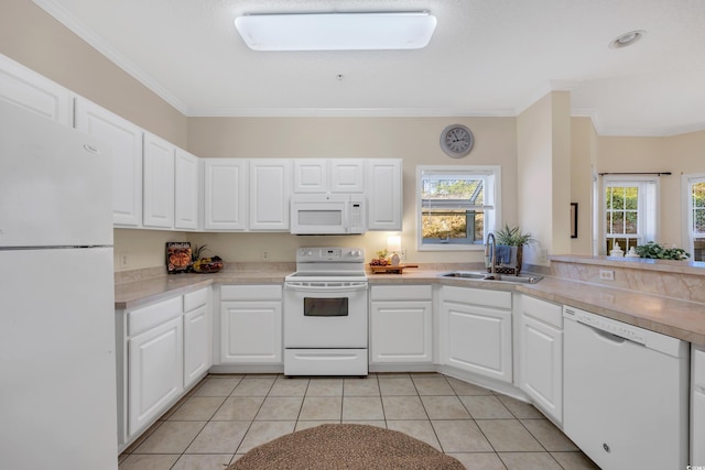 kitchen featuring white appliances, light tile patterned floors, crown molding, and a sink