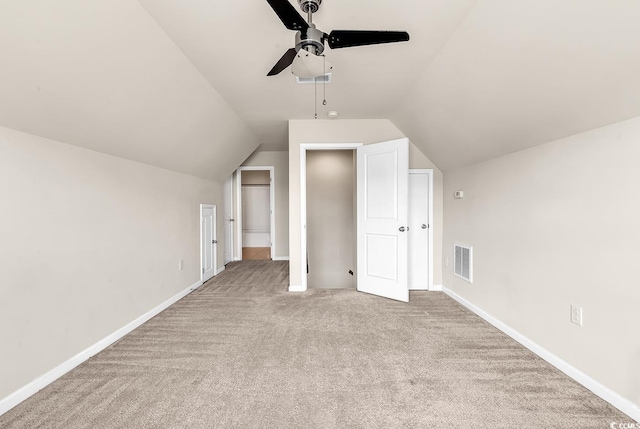 bonus room featuring lofted ceiling, carpet floors, visible vents, and baseboards