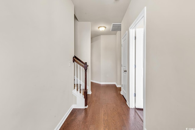 corridor featuring stairway, wood finished floors, visible vents, and baseboards