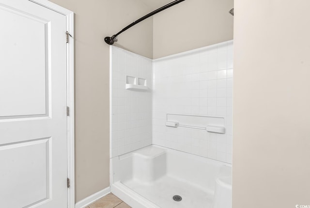 bathroom featuring tile patterned flooring and a shower