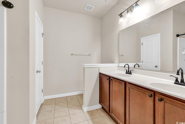 bathroom with tile patterned flooring, visible vents, a sink, and double vanity