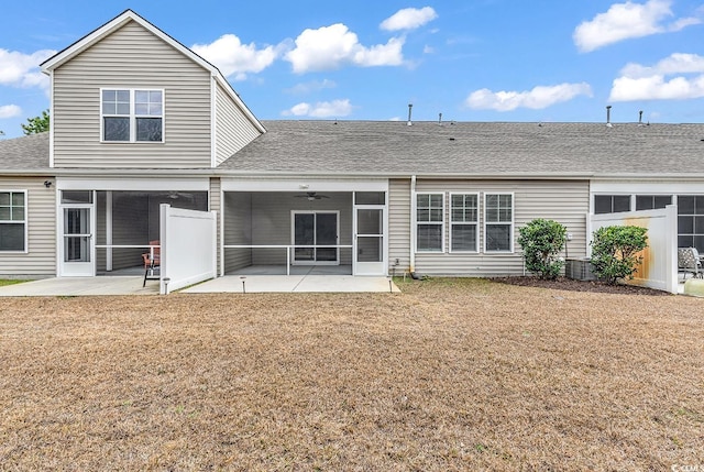 back of house with a yard, a sunroom, and a patio