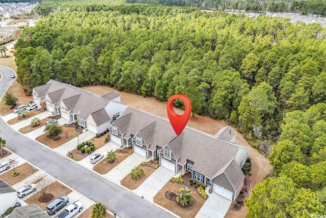 birds eye view of property with a forest view and a residential view