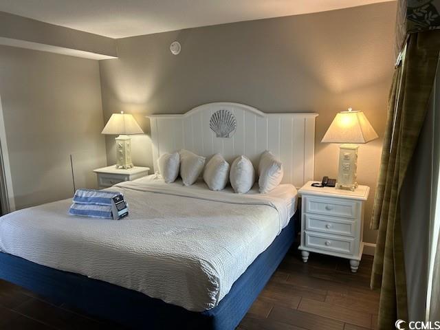 bedroom with dark wood finished floors