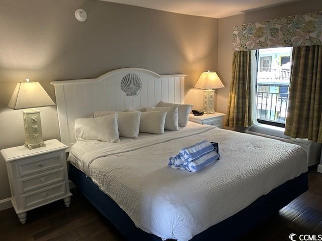 bedroom with dark wood-type flooring