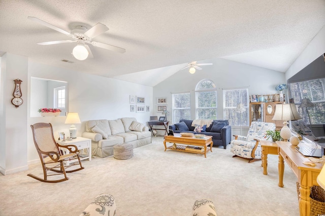 living area with a healthy amount of sunlight, visible vents, and light colored carpet