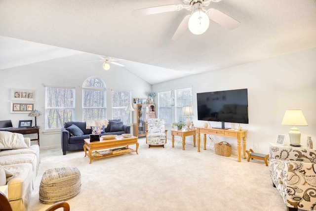 living room featuring carpet floors, ceiling fan, vaulted ceiling, and a textured ceiling