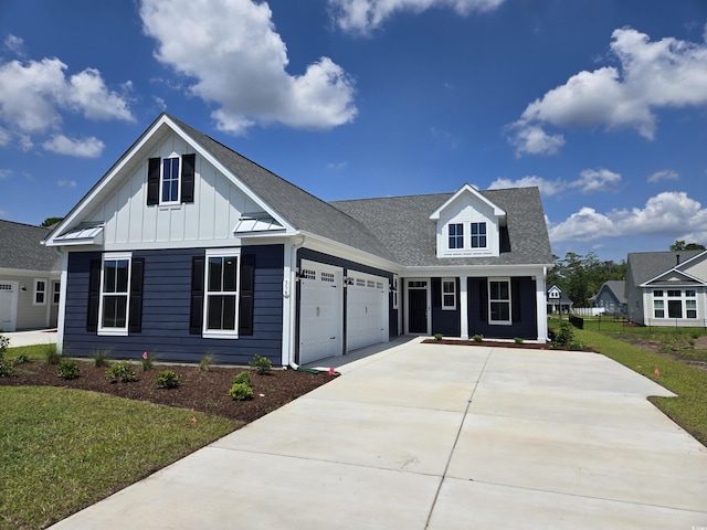 358 Starlit Way, Myrtle Beach, SC 29579 - view of front of property with board and batten siding, concrete driveway, a garage, a front yard, and a porch