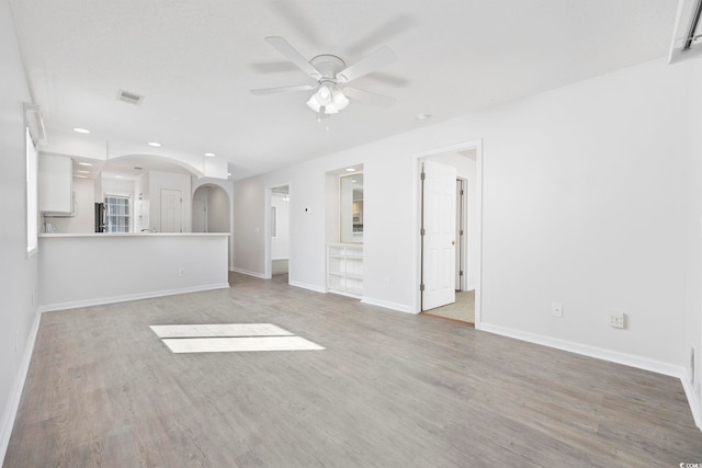 4430 Eastport Blvd Unit L5, Little River, SC 29566 - unfurnished living room featuring arched walkways, baseboards, recessed lighting, wood finished floors, and ceiling fan