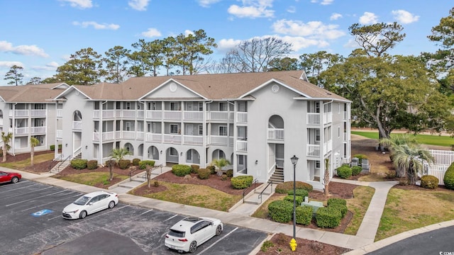 view of building exterior with uncovered parking